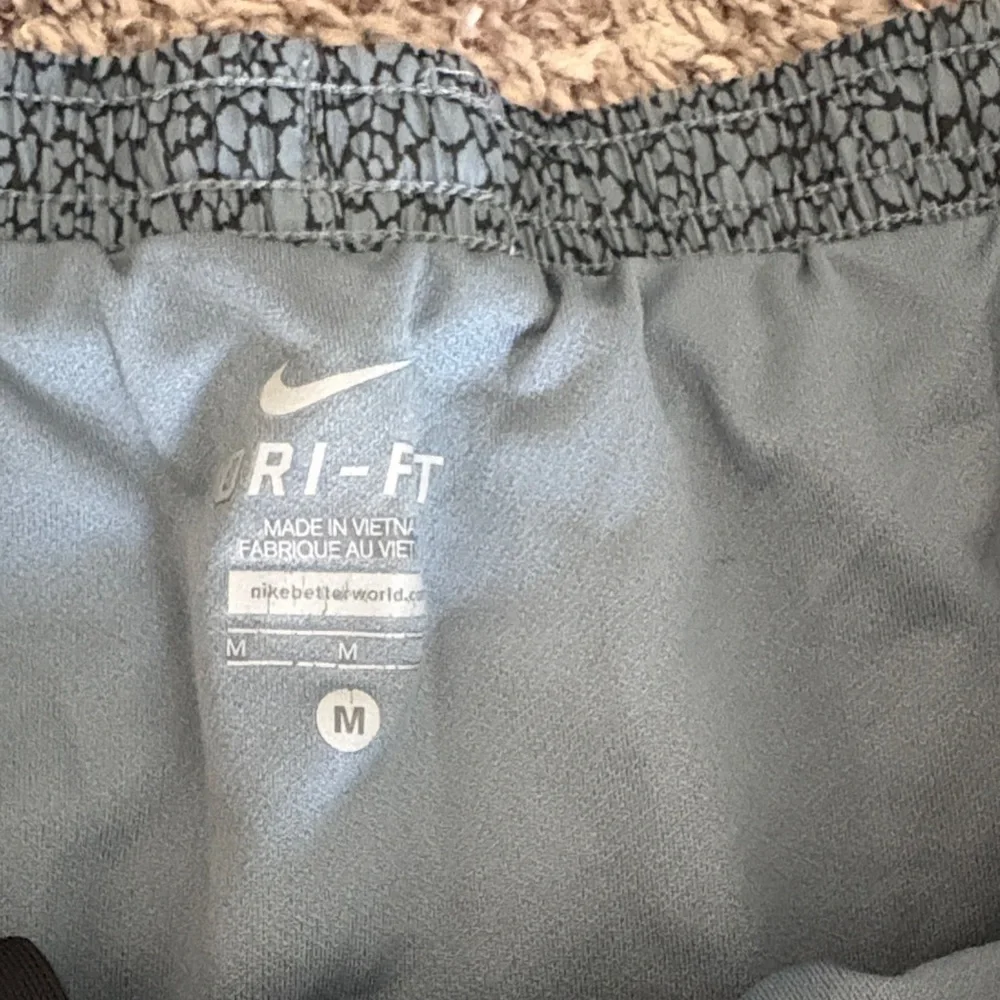 Nike Women's Teal Patterned Athletic Shorts with Black Accents